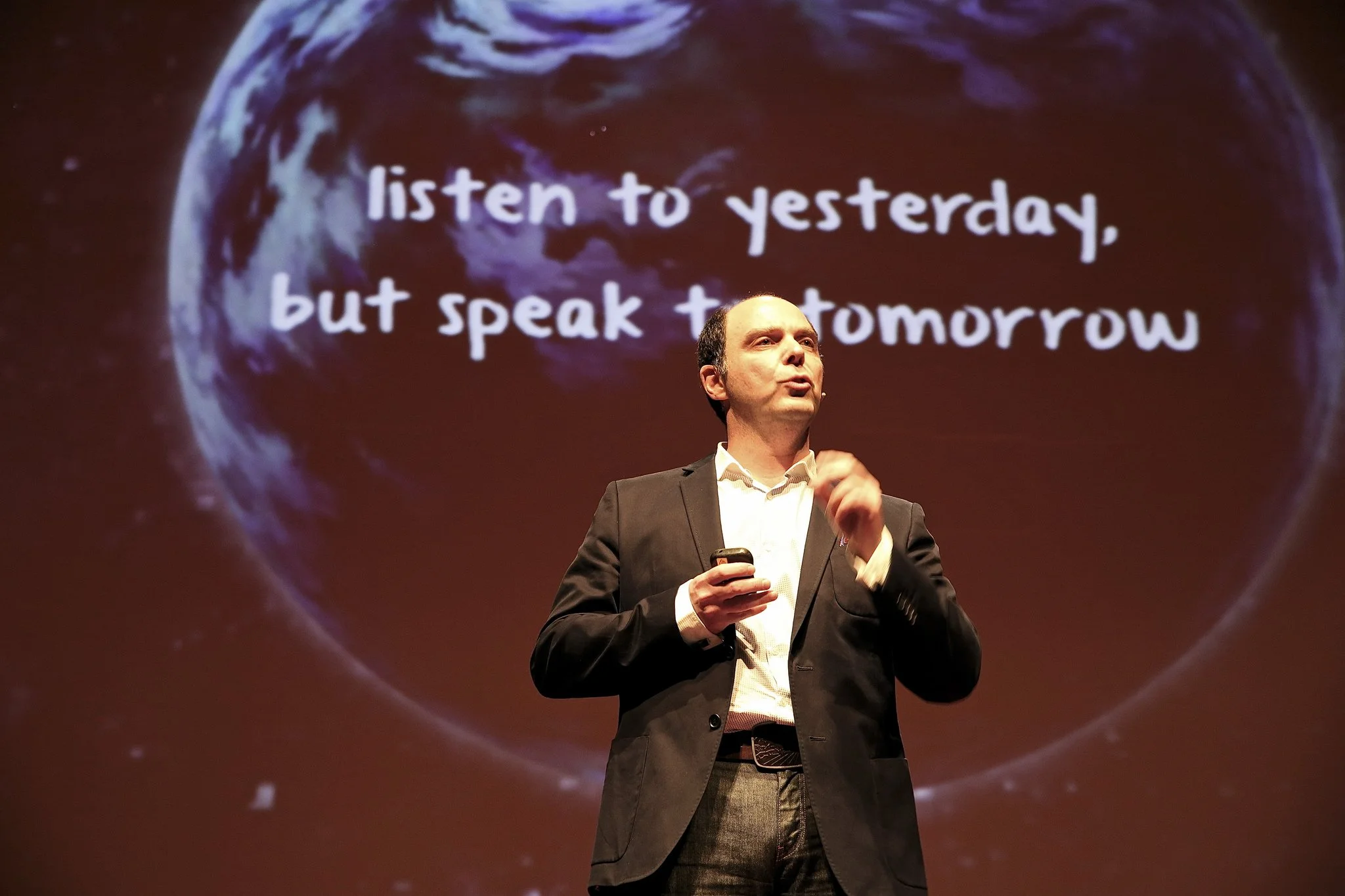 Morris Misel presenting on stage at a major business conference.